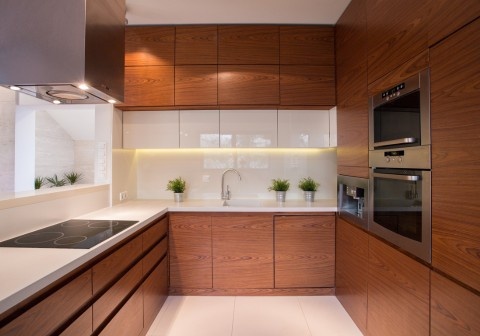 Custom kitchen cabinetry in Melbourne featuring dark cabinets, natural wood, and matte finishes